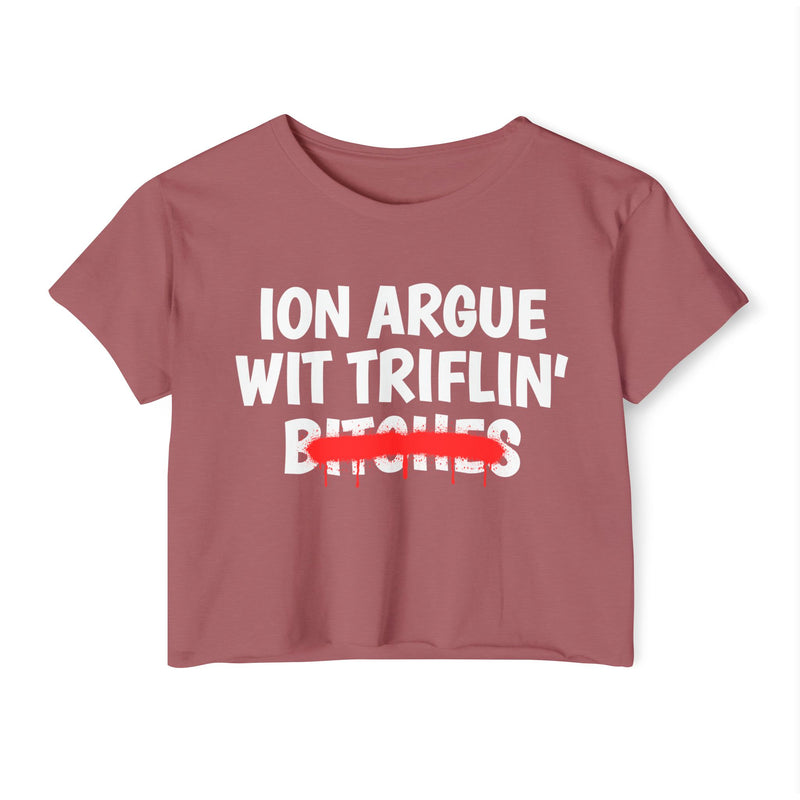 Smoked Paprika crop top with white printed statement graphic, front view: 'ION ARGUE WIT TRIFLIN'' in bold all-caps letters, 'BITCHES' crossed out in a red graffiti strike with paint drips.