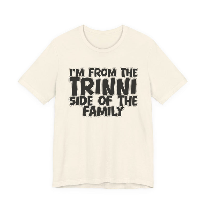 Soft Cream t-shirt with 'I'M FROM THE TRINNI SIDE OF THE FAMILY' in black hand-drawn bubble lettering on the chest, front flat-lay mockup view.