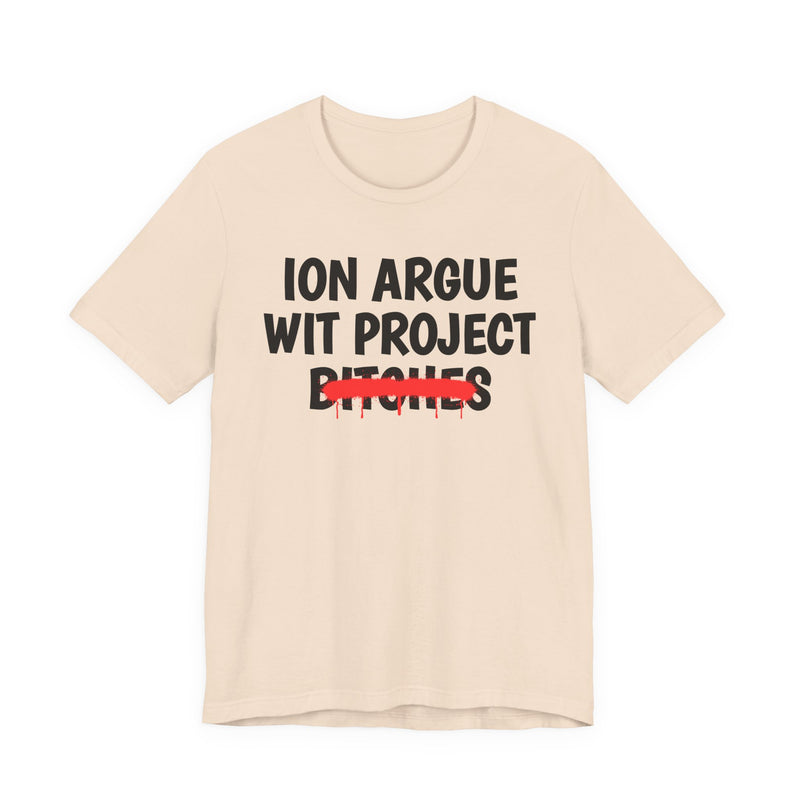 Soft Cream t-shirt with black stacked uppercase "ION ARGUE WIT PROJECT BITCHES" lettering, "BITCHES" crossed by a red spray-paint strike with drips, front flat-lay view.