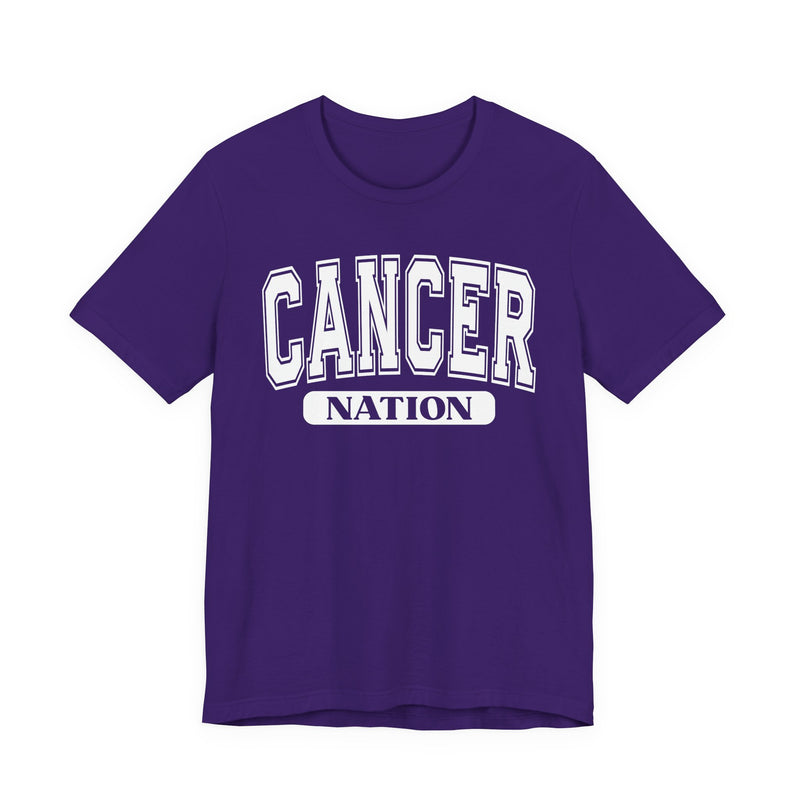 Team purple t-shirt with white arched CANCER collegiate lettering over a black NATION pill badge, front flat-lay view.