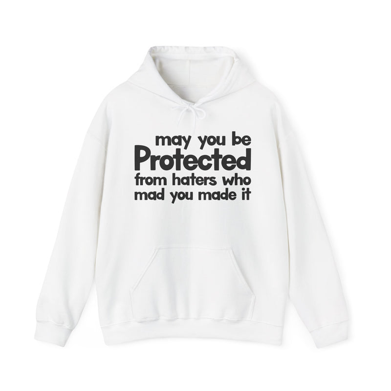 May You Be Protected From Haters Who Mad You Made It — Hoodie fabric detail close-up: MAY YOU BE PROTECTED FROM HATERS WHO MAD YOU MADE IT in bold statement lettering. Street Talk Designs protection statement apparel.