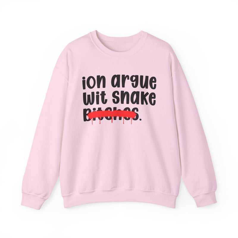 Light Pink sweatshirt with black printed statement graphic, front view: 'ion argue' and 'Wit snake' in rounded chunky lowercase lettering over distressed 'Bitches.' crossed by a red spray-paint strike with paint drips.
