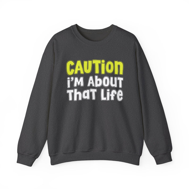 Sweatshirt in Dark Heather with lettering reading "CAUTION I'M ABOUT THAT LIFE", front view.