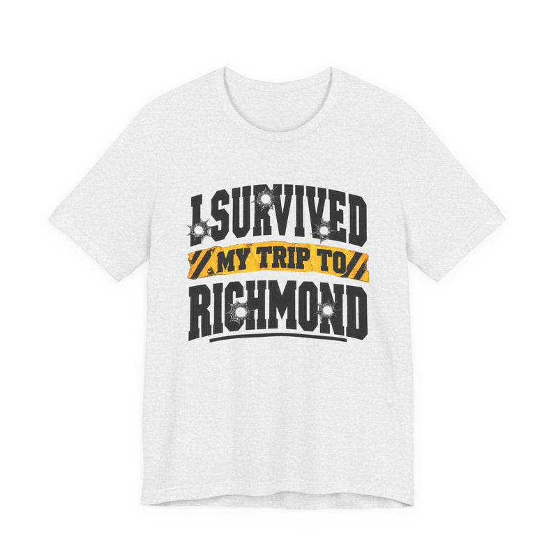 T-Shirt product photo with arched collegiate lettering reading "I SURVIVED" with bullet-hole decals, a caution-tape band reading "MY TRIP TO", and large block letters reading "RICHMOND", front view.
