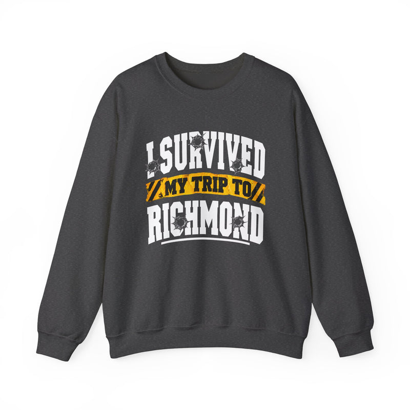 Sweatshirt product photo with arched collegiate lettering reading "I SURVIVED" with bullet-hole decals, a caution-tape band reading "MY TRIP TO", and large block letters reading "RICHMOND", front view.