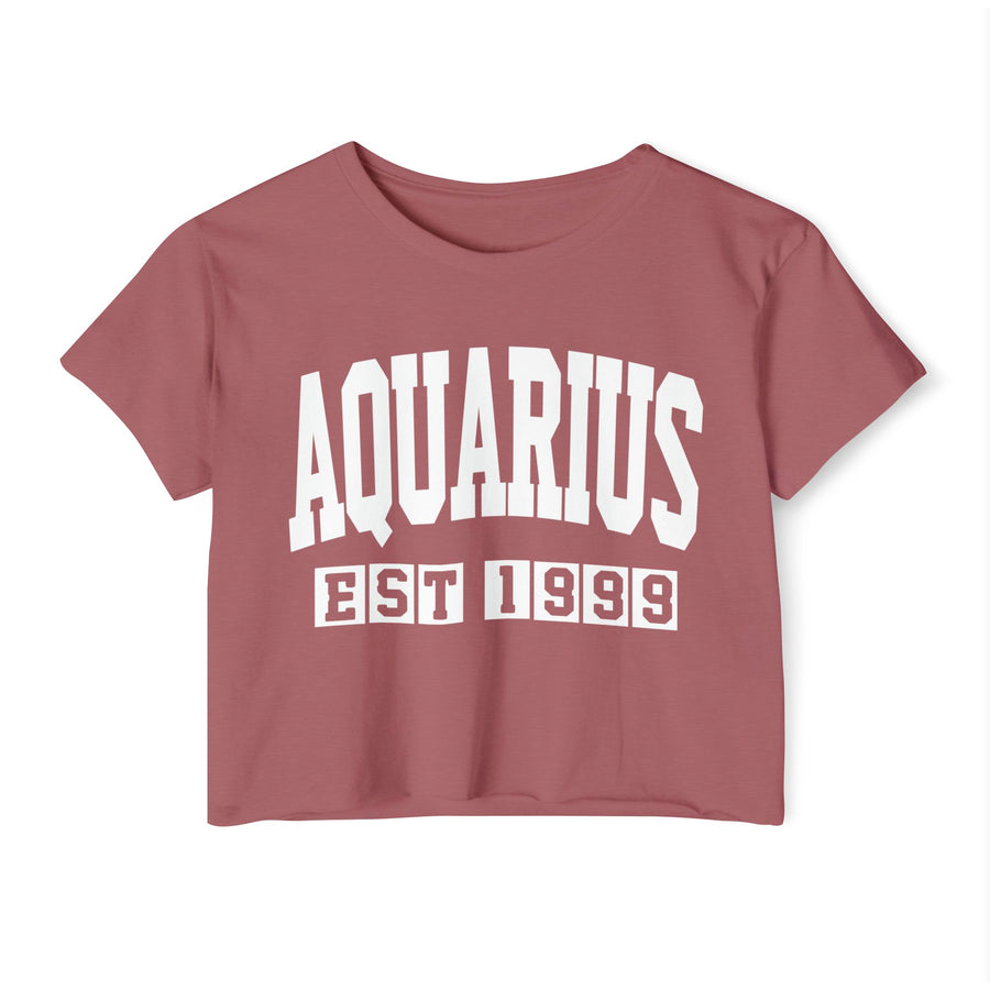 Red crop top with white zodiac graphic lettering reading AQUARIUS with a water-bearer zodiac graphic, front flat-lay view.