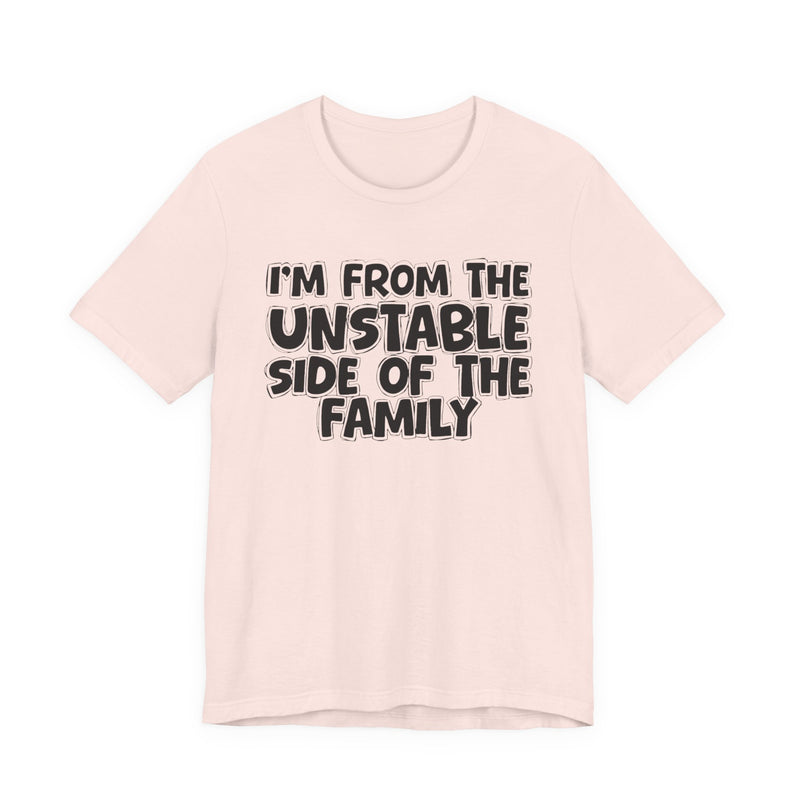 Soft Pink t-shirt with white outlined bubble lettering reading 'I'M FROM THE UNSTABLE SIDE OF THE FAMILY', front flat-lay view.