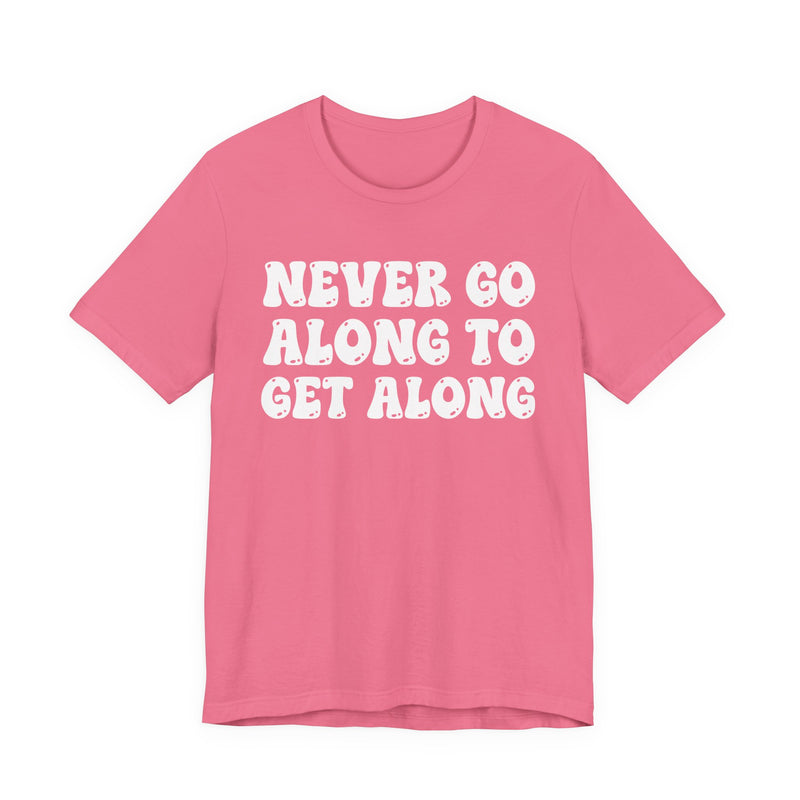 Pink t-shirt with white collegiate lettering reading NEVER GO ALONG TO GET ALONG, flat-lay view.