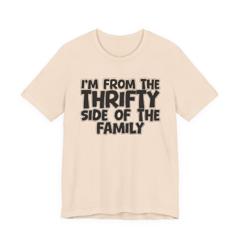 Soft Cream t-shirt with white outlined bubble lettering reading 'I'M FROM THE THRIFTY SIDE OF THE FAMILY', front flat-lay view.