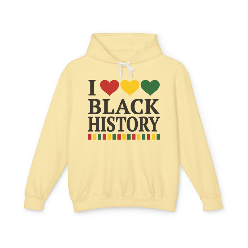 Front flat-lay of the I Love Black History hoodie in Butter: black 'I' with red, gold, and green hearts above black 'BLACK HISTORY' collegiate lettering, with a red, gold, and green stripe bar beneath the text.