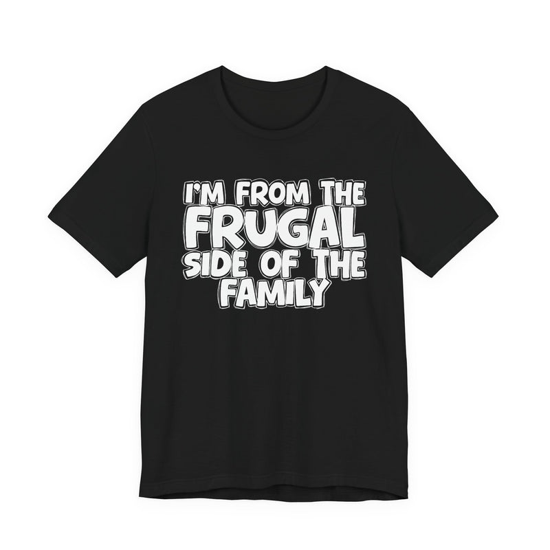 Black t-shirt with 'I'M FROM THE FRUGAL SIDE OF THE FAMILY' in white hand-drawn bubble lettering on the chest, front flat-lay mockup view.