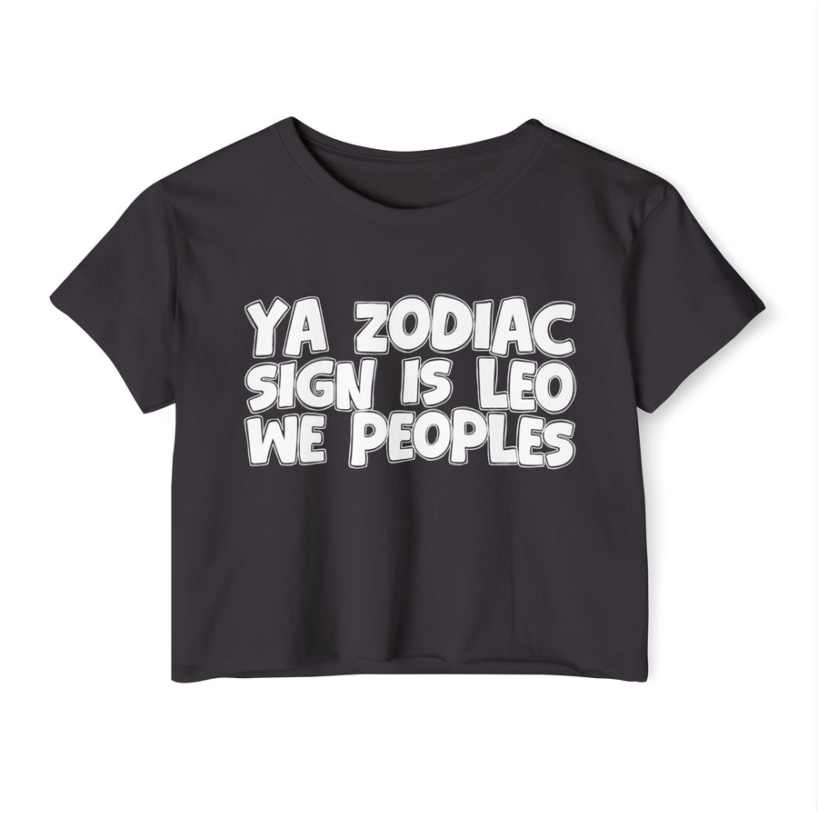 Black crop top with white 'YA ZODIAC SIGN IS LEO WE PEOPLES' rounded collegiate bubble lettering, front flat-lay view.