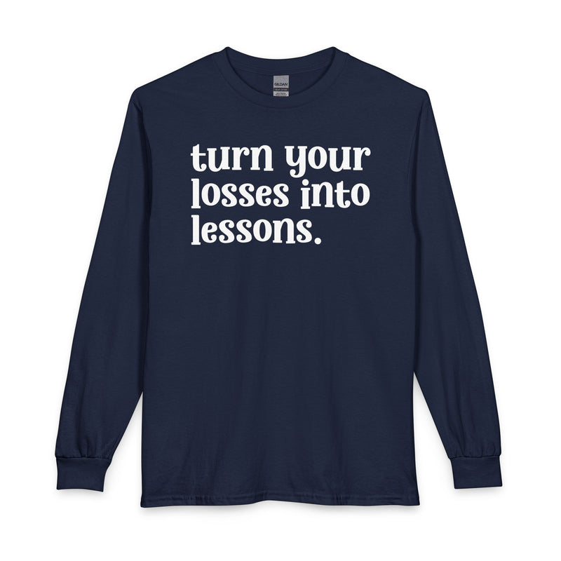 Navy long sleeve t-shirt with white "turn your losses into lessons." lettering, front view.