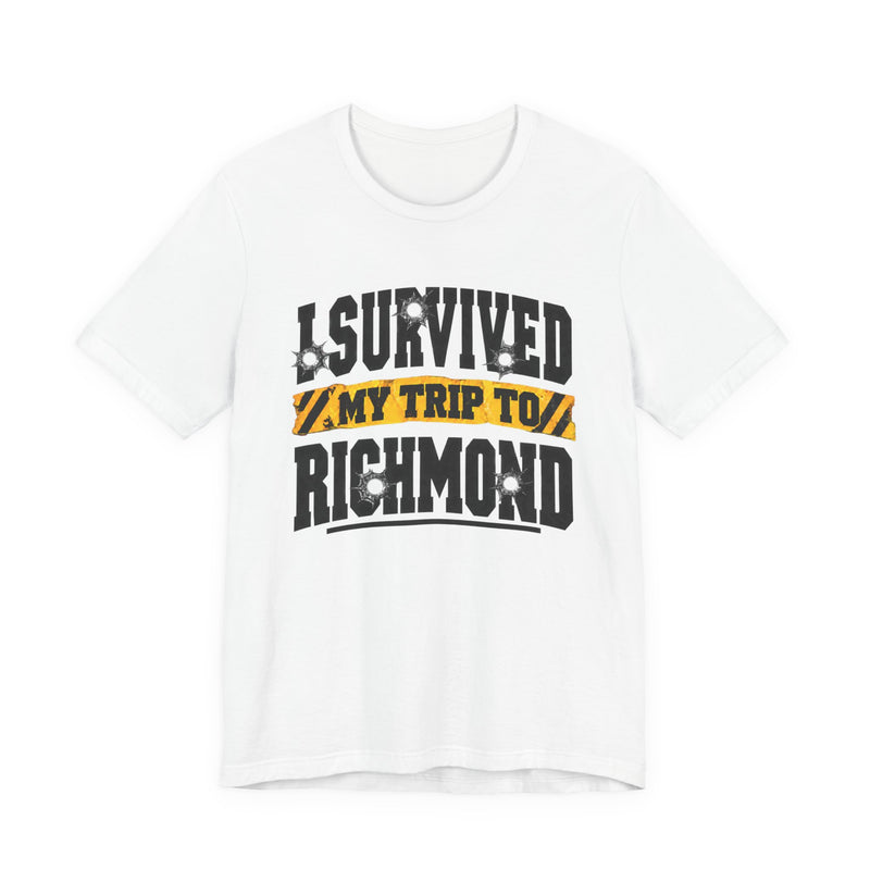 T-Shirt product photo with arched collegiate lettering reading "I SURVIVED" with bullet-hole decals, a caution-tape band reading "MY TRIP TO", and large block letters reading "RICHMOND", front view.