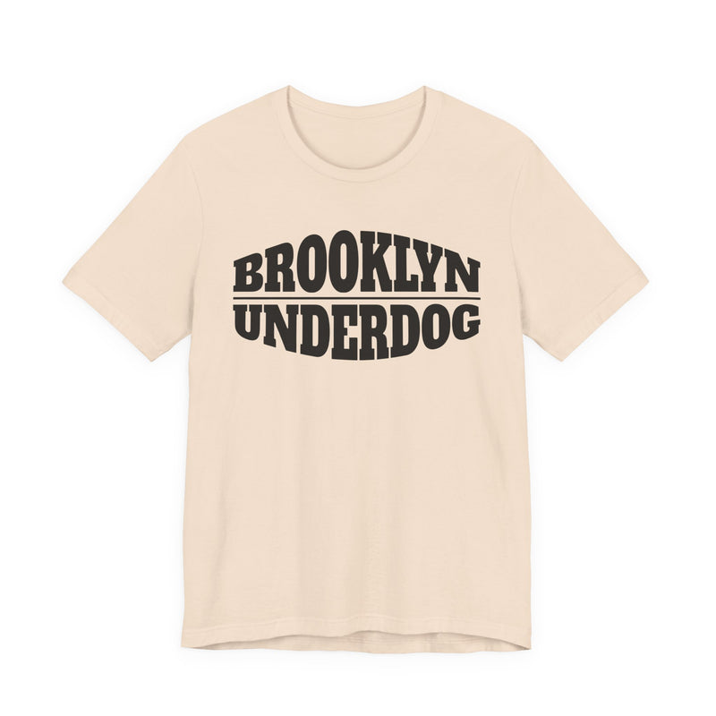 Natural T-shirt with black arched BROOKLYN and inverted-arch UNDERDOG collegiate print, front flat-lay view