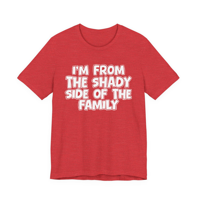light t-shirt with ‘I’M FROM THE SHADY SIDE OF THE FAMILY’ statement text in bold outline lettering, front flat-lay view.