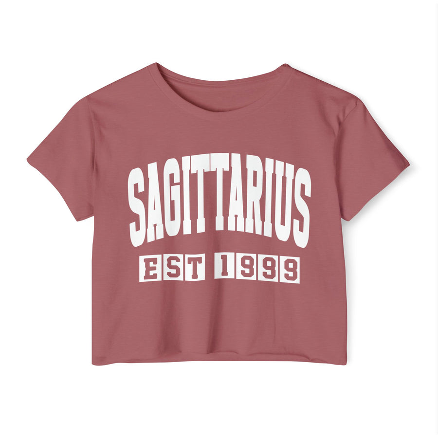 Mauve crop top with white arched SAGITTARIUS lettering and boxed EST 1999 print, front view