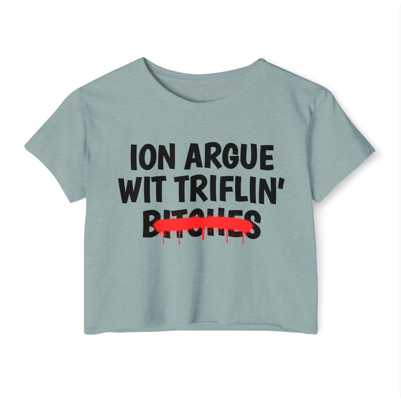 Stonewash Green crop top with black printed statement graphic, front view: 'ION ARGUE WIT TRIFLIN'' in bold all-caps letters, 'BITCHES' crossed out in a red graffiti strike with paint drips.