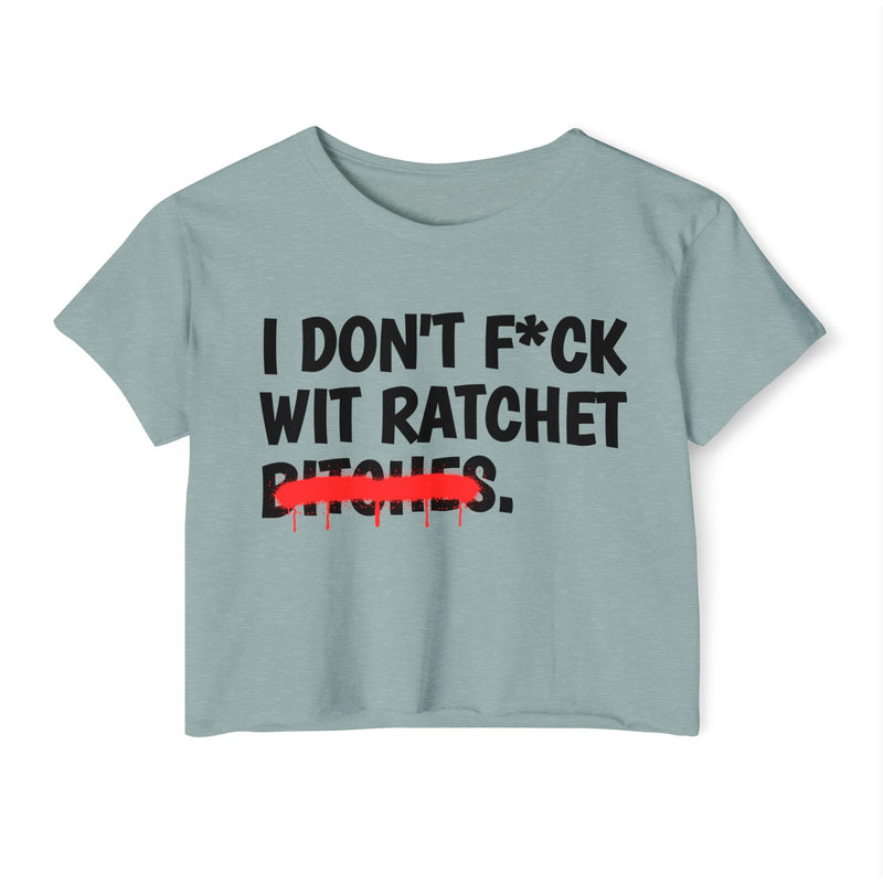 Sky Blue crop top with black bold lettering reading I DON'T F*CK WIT RATCHET BITCHES, crossed by a red dripping strikethrough, front flat-lay view.