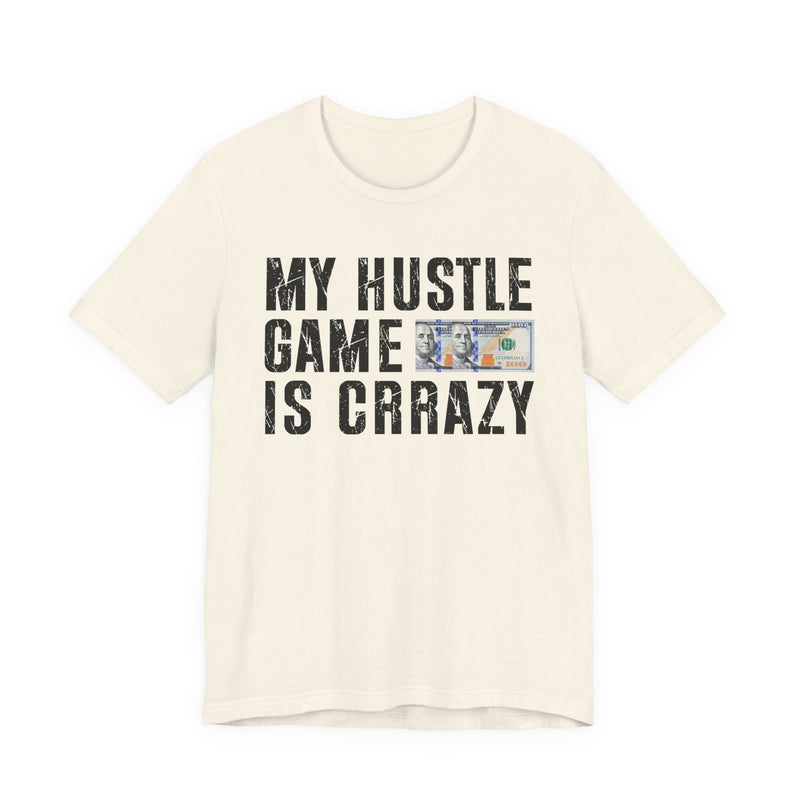 White t-shirt with dark bold grind lettering reading MY HUSTLE GAME IS CRAZY, front flat-lay view.