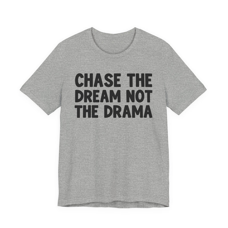 Grey t-shirt with black bold statement lettering reading CHASE THE DREAM NOT THE DRAMA, front flat-lay view.