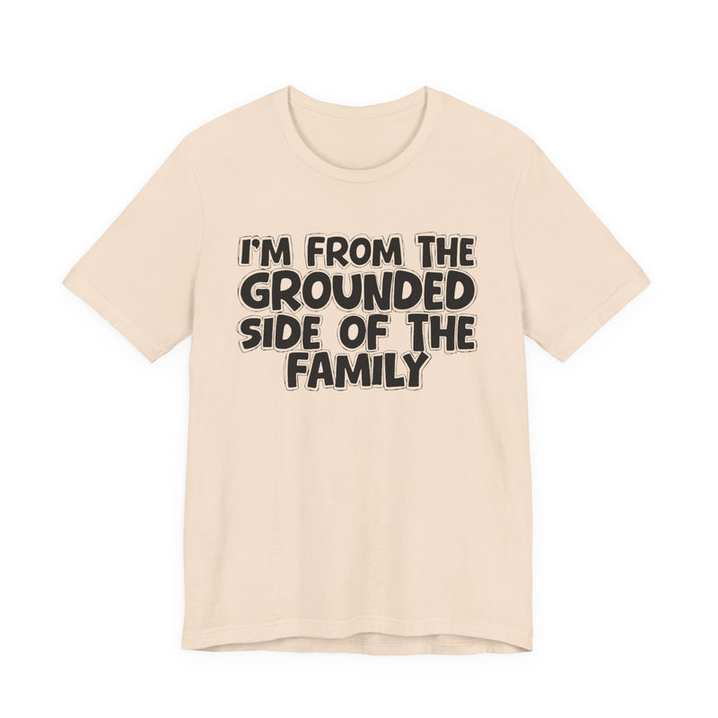 Natural t-shirt with 'I'M FROM THE GROUNDED SIDE OF THE FAMILY' in black hand-drawn bubble lettering on the chest, front flat-lay mockup view.