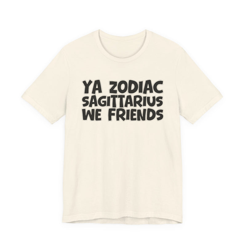 Natural t-shirt with black 'YA ZODIAC SAGITTARIUS WE FRIENDS' cartoon bubble lettering, front flat-lay view.