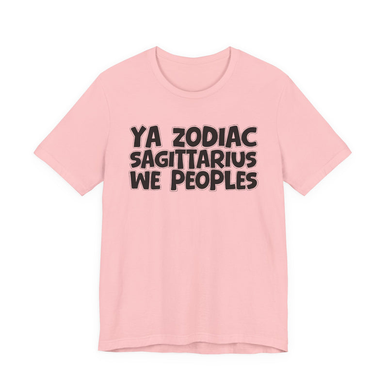 Light pink t-shirt with black hand-lettered YA ZODIAC SAGITTARIUS WE PEOPLES print, front flat-lay view.