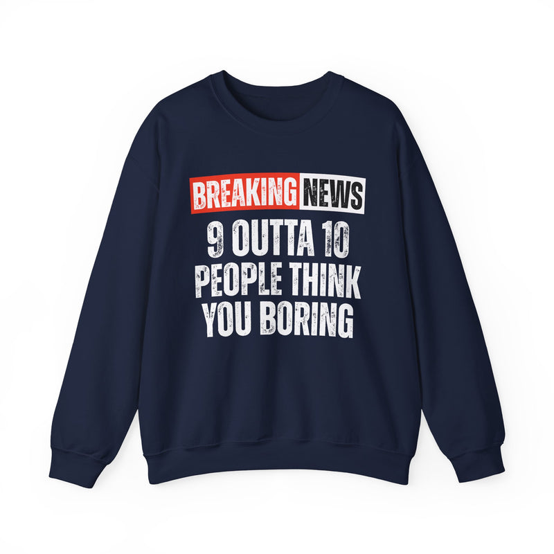 BREAKING NEWS banner graphic with distressed headline text '9 OUTTA 10 PEOPLE THINK YOU BORING' - sweatshirt in charcoal, front view, product mockup on white background