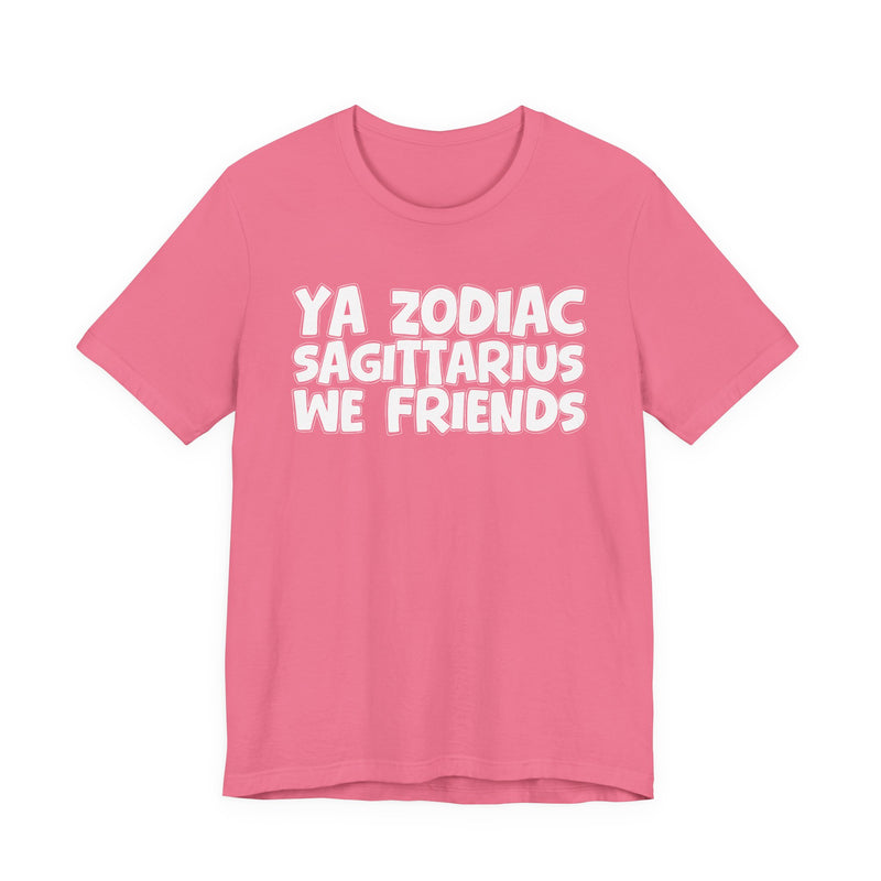 Charity Pink t-shirt with white 'YA ZODIAC SAGITTARIUS WE FRIENDS' cartoon bubble lettering, front flat-lay view.