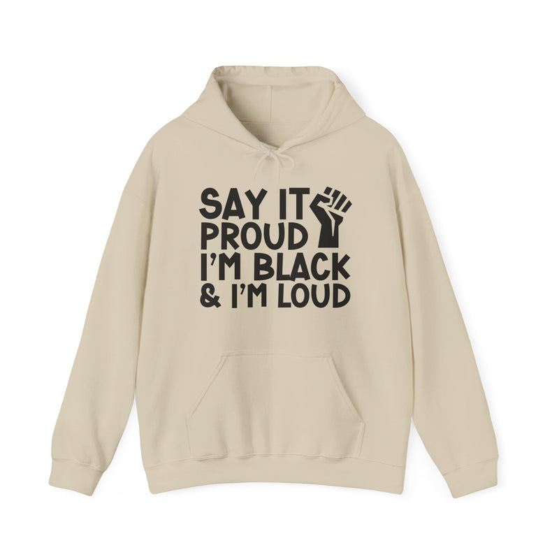 Sand hoodie with stacked text reading SAY IT PROUD, I'M BLACK, I'M LOUD with a raised-fist icon between the lines, front view.