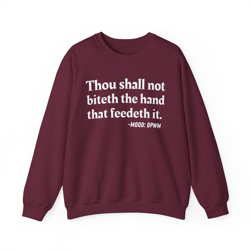 Sweatshirt with text design reading “THOU SHALL NOT BITETH THE HAND THAT FEEDETH IT”, front view