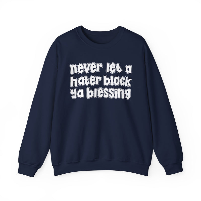 Navy sweatshirt with white outlined bubble lettering reading "never let a hater block ya blessing", front flat-lay view.