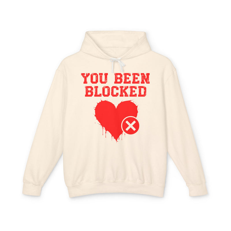 Pink hoodie with white bold statement lettering with blocked-heart graphic reading YOU BEEN BLOCKED, front flat-lay view.