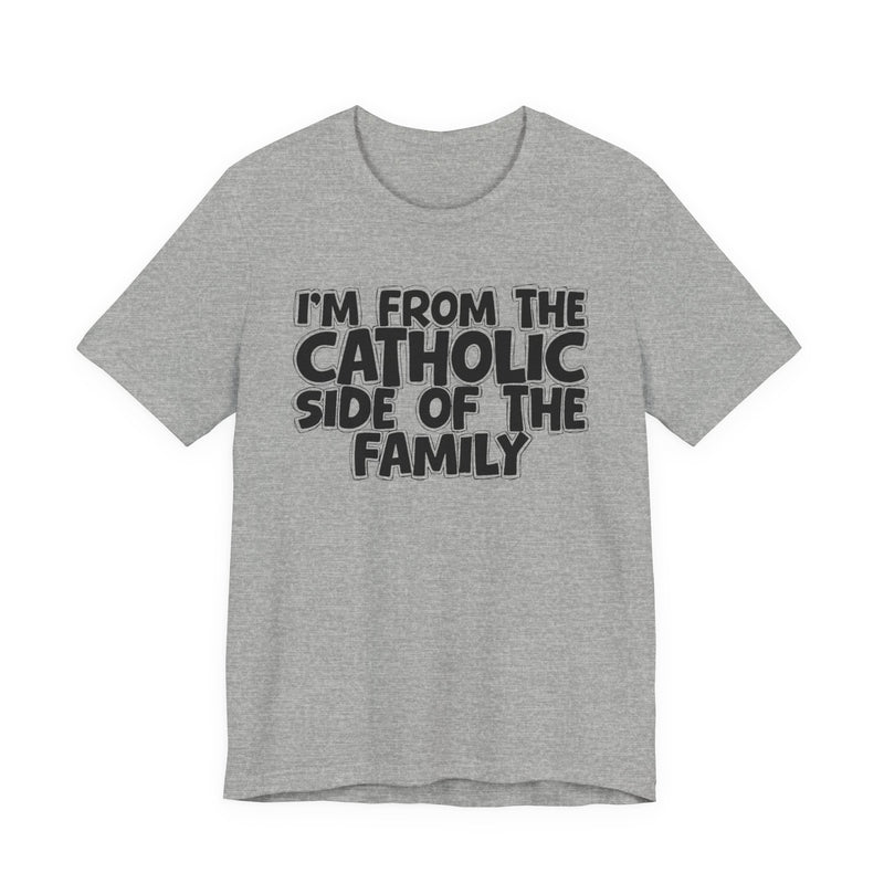 Athletic Heather t-shirt with white outlined bubble lettering reading 'I'M FROM THE CATHOLIC SIDE OF THE FAMILY', front flat-lay view.