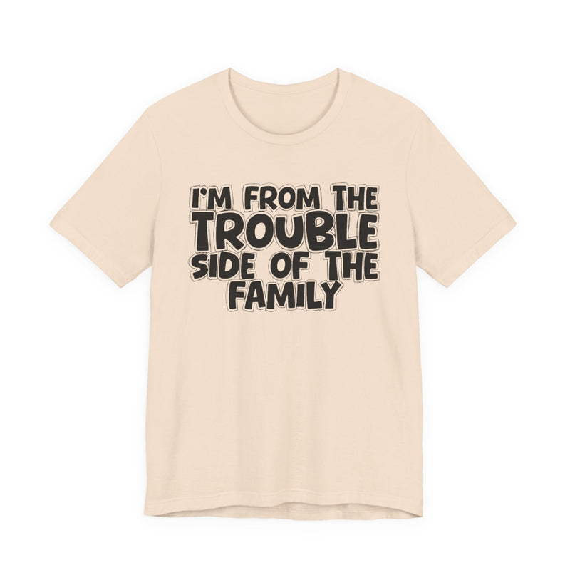 Soft Cream t-shirt, printed with the "I'M FROM THE TROUBLE SIDE OF THE FAMILY" statement in bold outlined bubble lettering, front flat-lay view.