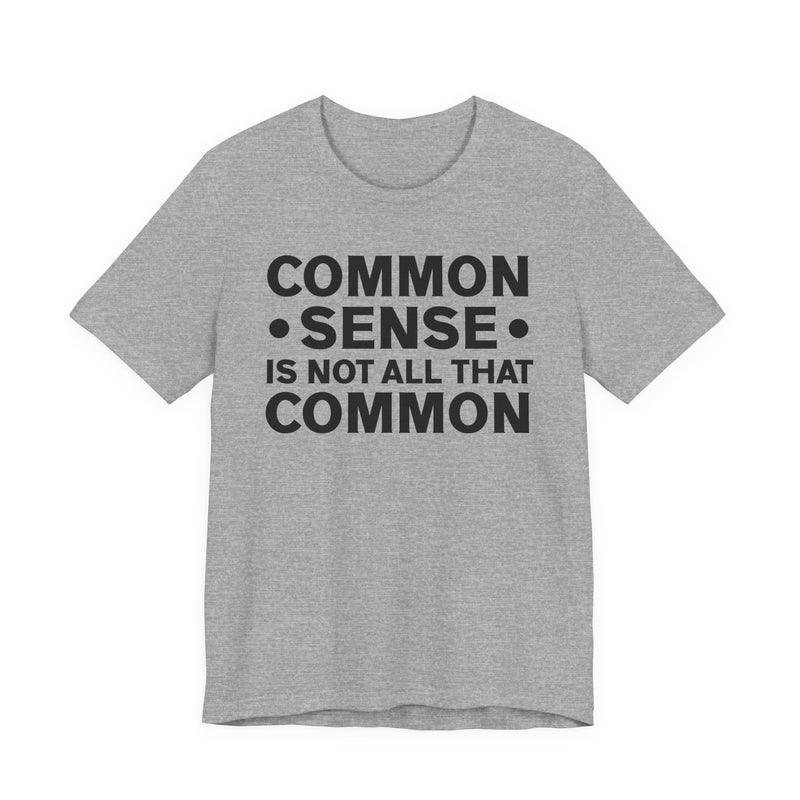Sport grey t-shirt with milgreen collegiate lettering reading COMMON SENSE IS NOT ALL THAT COMMON, flat-lay view.