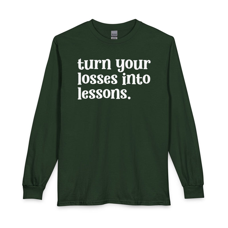 Forest green long sleeve t-shirt with white "turn your losses into lessons." lettering, front view.