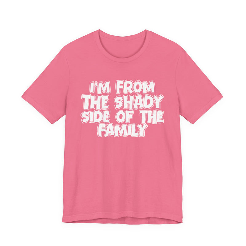 light t-shirt with ‘I’M FROM THE SHADY SIDE OF THE FAMILY’ statement text in bold outline lettering, front flat-lay view.
