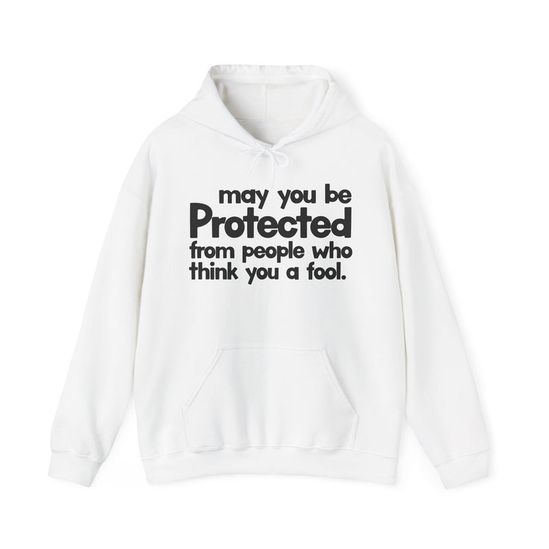 May You Be Protected From People Who Think You A Fool — Hoodie fabric detail close-up: MAY YOU BE PROTECTED FROM PEOPLE WHO THINK YOU A FOOL in bold statement lettering. Street Talk Designs protection statement apparel.