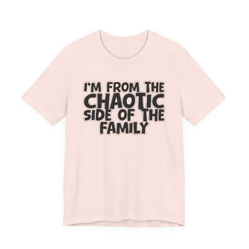 light t-shirt with ‘I’M FROM THE CHAOTIC SIDE OF THE FAMILY’ statement text in bold outline lettering, front flat-lay view.