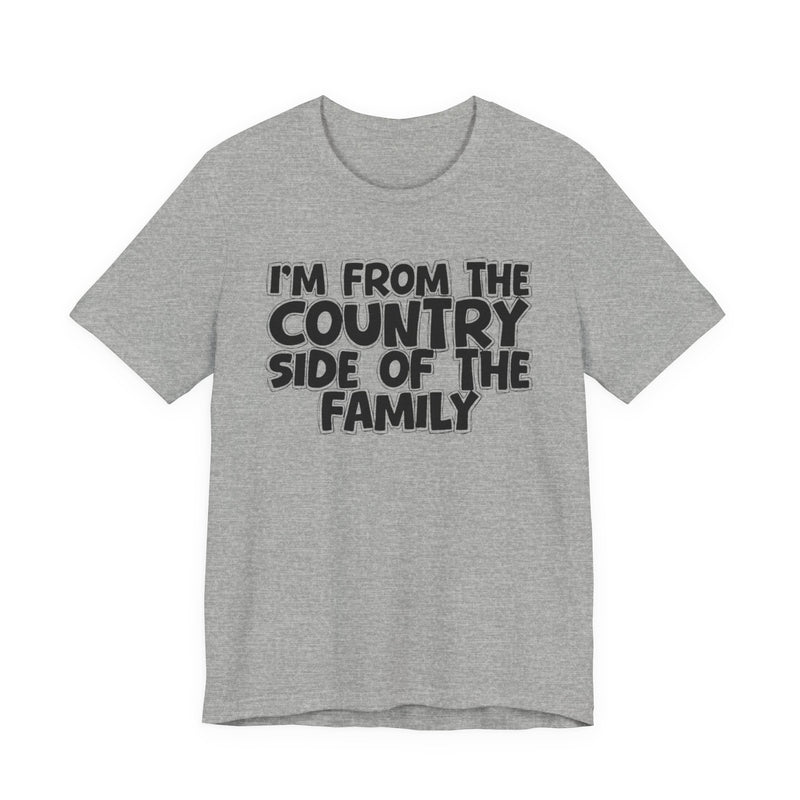 Athletic Heather t-shirt with white outlined bubble lettering reading 'I'M FROM THE COUNTRY SIDE OF THE FAMILY', front flat-lay view.