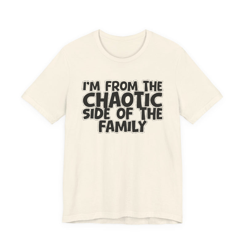 light t-shirt with ‘I’M FROM THE CHAOTIC SIDE OF THE FAMILY’ statement text in bold outline lettering, front flat-lay view.