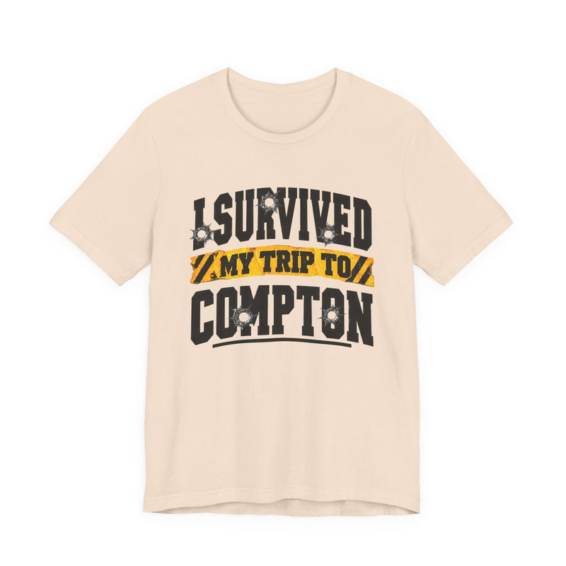 T-Shirt with collegiate lettering reading I SURVIVED MY TRIP TO COMPTON, front view.
