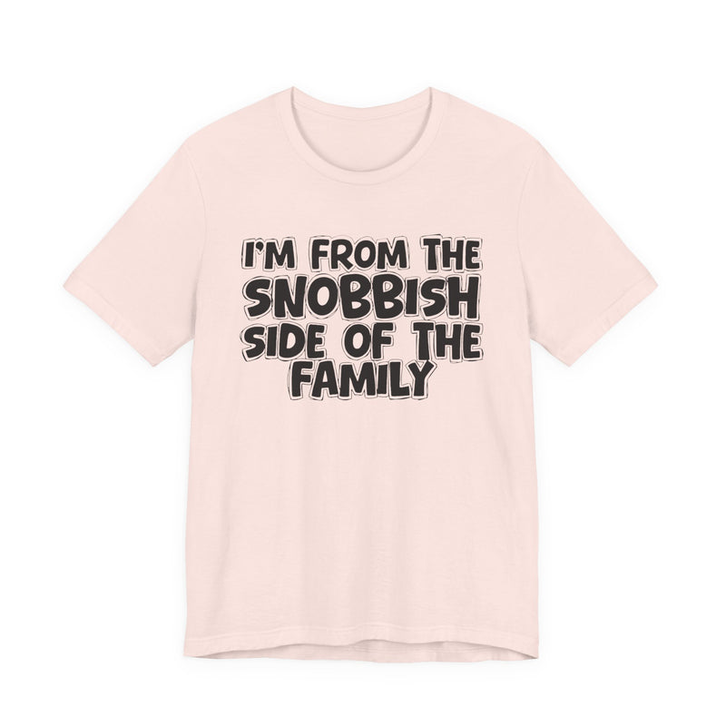 Soft Pink t-shirt with white outlined bubble lettering reading 'I'M FROM THE SNOBBISH SIDE OF THE FAMILY', front flat-lay view.