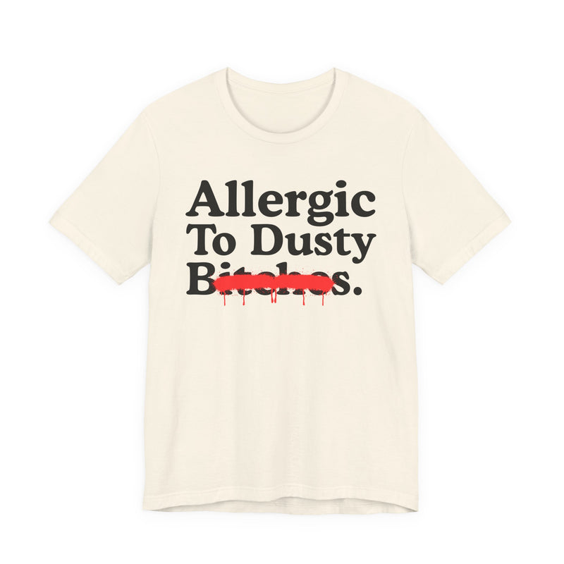 Natural T-Shirt with bold statement lettering reading ALLERGIC TO DUSTY BITCHES, front flat-lay view.