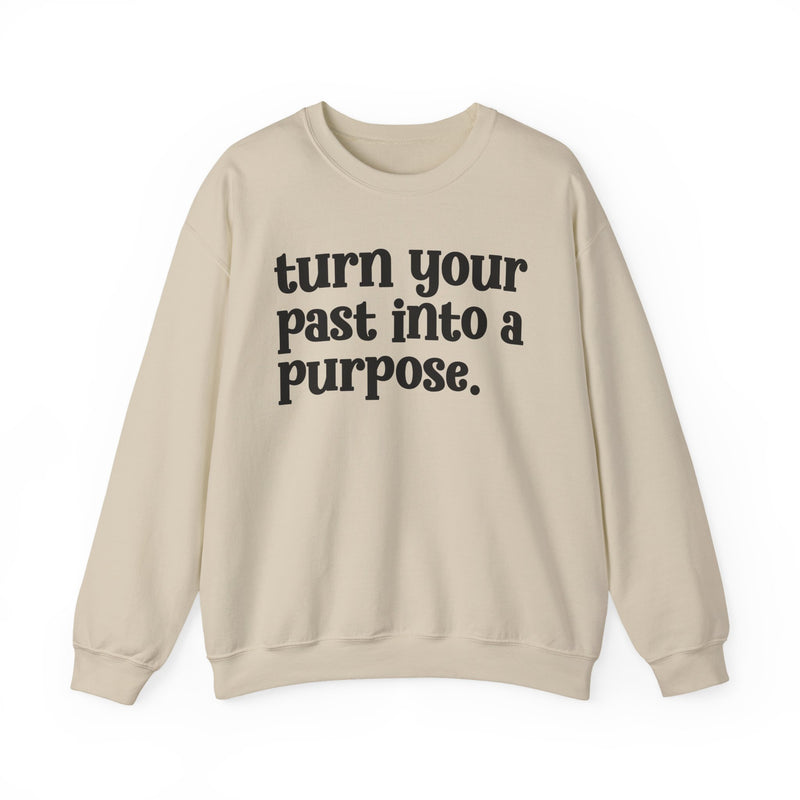 Sand sweatshirt with black "turn your past into a purpose." lettering, front view.