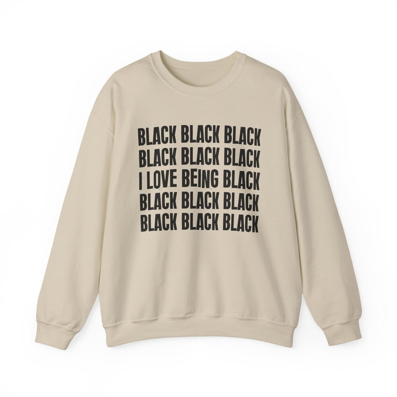 Sand sweatshirt with stacked ‘BLACK BLACK BLACK / I LOVE BEING BLACK / BLACK BLACK BLACK’ block text graphic in dark-contrast print, front flat-lay mockup view
