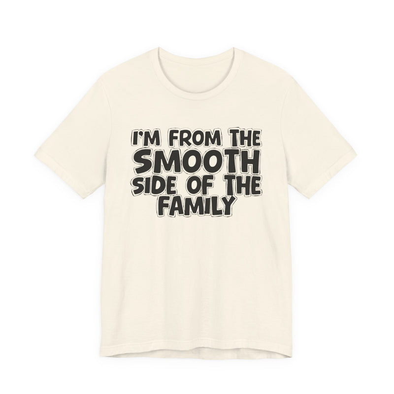 Natural t-shirt, printed with the "I'M FROM THE SMOOTH SIDE OF THE FAMILY" statement in bold outlined bubble lettering, front flat-lay view.