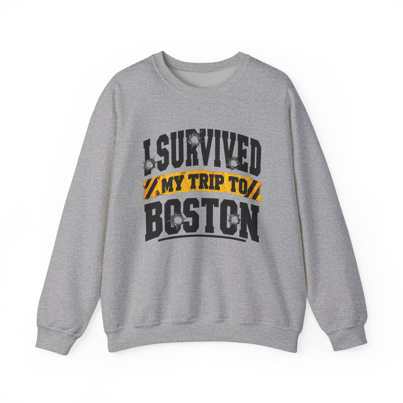 Sport grey sweatshirt with black block lettering reading I SURVIVED MY TRIP TO PHOENIX, with bullet-hole accents and a yellow caution-tape banner, front flat-lay view.